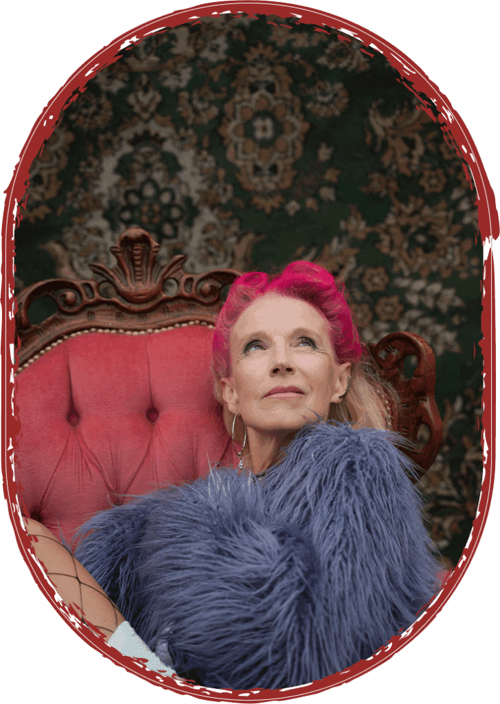 woman with pink hair sitting in fur jacket