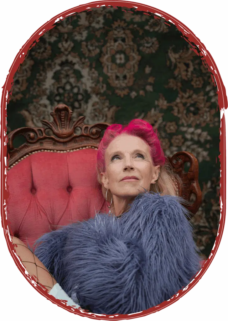 woman with pink hair sitting in fur jacket