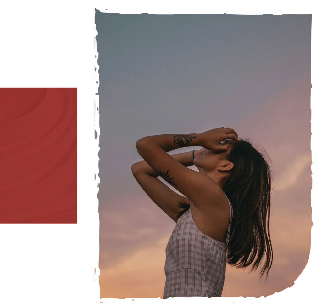 a woman with tattoo looking at the sky