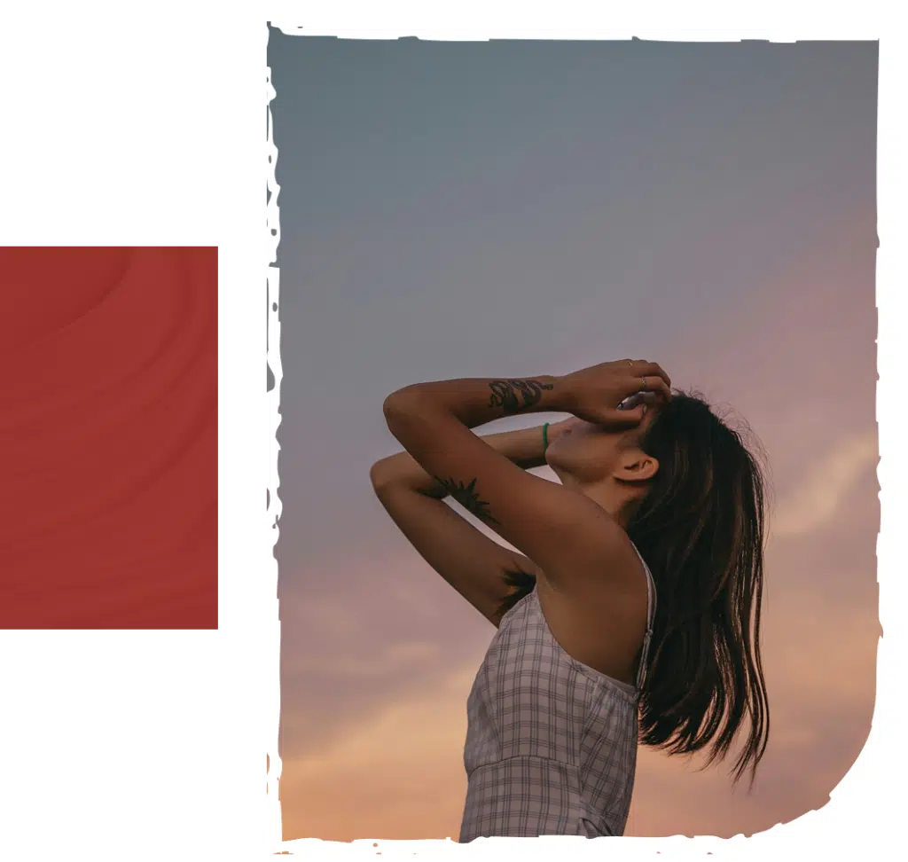 a woman with tattoo looking at the sky